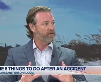 Man in suit explaining five steps to take after an accident during a Suncoast View interview segment.