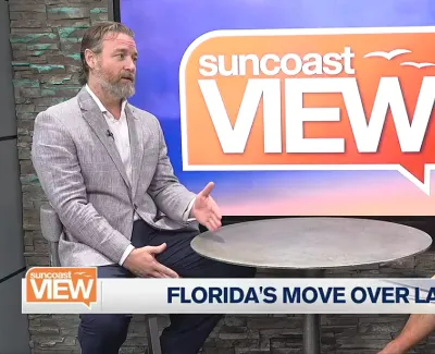 Two hosts discussing Florida's Move Over Law on Suncoast View TV show set with logo and topic banner