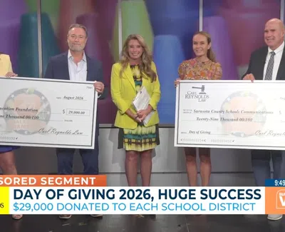 Five people hold large donation checks for $29,000 each during Day of Giving 2026 sponsored segment.