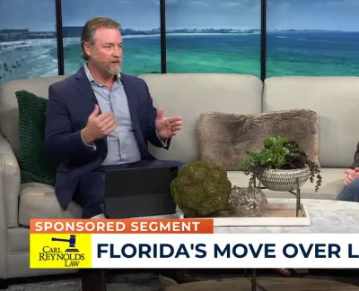 Two hosts discuss Florida's Move Over Law in a studio with ocean view and plants on the table.