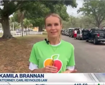 Attorney Kamila Brannan speaking outdoors near parked cars and trees during a news segment