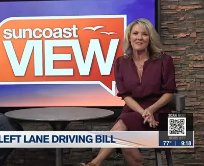 Two news anchors sit in front of a Suncoast View backdrop discussing Left Lane Driving Bill on set.