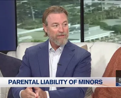 Man in blue suit discussing parental liability of minors on local TV morning show set.