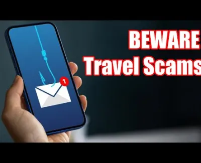 Hand holding phone with phishing email icon and text warning about travel scams in bold red letters.