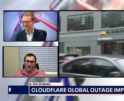 News broadcast screen showing two commentators discussing Cloudflare global outage with Cloudflare office footage.