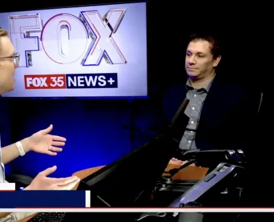 Two men discuss technology on Florida Live show with FOX 35 News+ screen in studio background