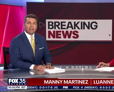 Two news anchors presenting breaking news on Fox 35 Orlando newsroom set with red and white theme.