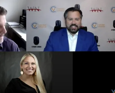Three people in a video conference, two men and one woman, smiling and engaged in discussion