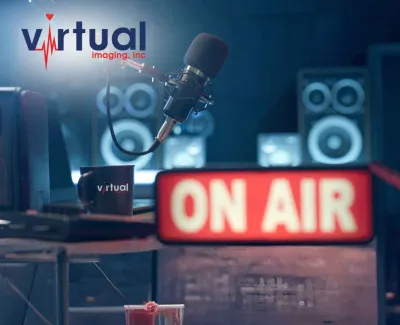 Radio studio setup with microphone, ON AIR sign, speakers, and Virtual Imaging logo in background.