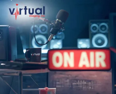 Podcast recording setup with microphone, speakers, Virtual Imaging logo, and illuminated ON AIR sign in studio.