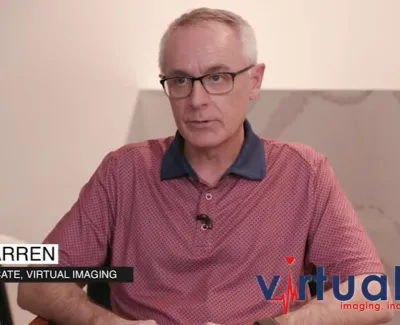 Man wearing glasses and a red polo shirt speaking in an interview with Virtual Imaging logo visible.