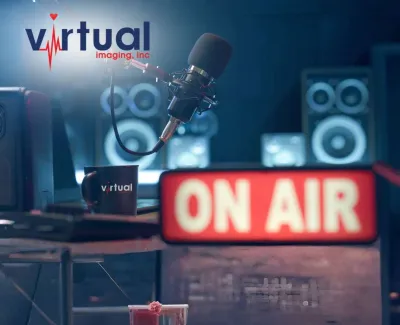 Podcast studio setup with microphone, speakers, ON AIR sign, and Virtual Imaging cup and logo.