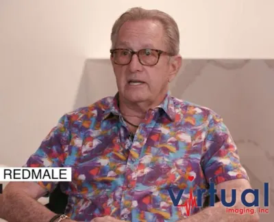 Retired dentist Dr. David Redmale wearing colorful shirt and glasses in a modern office setting with plants and Virtual Imaging logo.