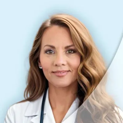 Portrait of a female doctor with long hair wearing a white coat and stethoscope on a light blue background.