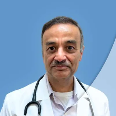 Middle-aged male doctor in white coat with stethoscope against a blue and light blue background.