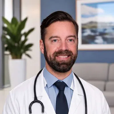 Smiling male doctor wearing a white coat and stethoscope against a blue background with a curved overlay.