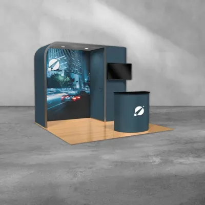 Modern trade show booth with curved walls, cityscape graphic, TV monitor, and branded counter on wood floor.