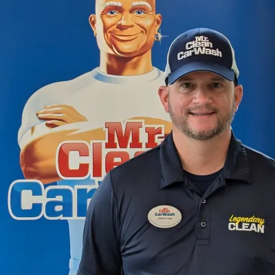 a man standing next to a poster