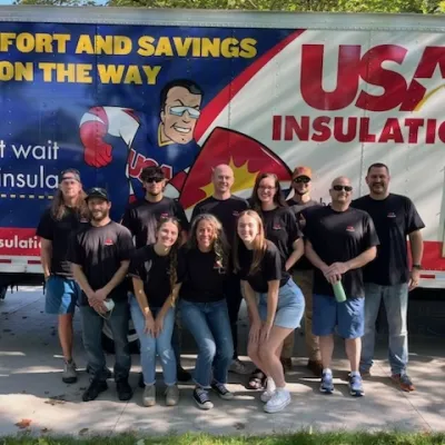 a group of people posing for a photo in front of a banner