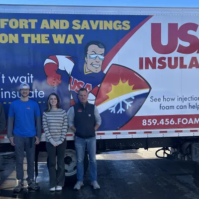 Group of professionals in front of USA Insulation truck promoting comfort and energy savings.