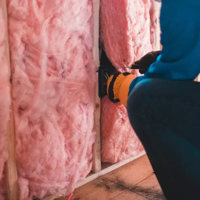 a person holding insulation