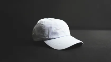 a white hat on a black surface