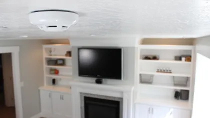 a room with a television and shelves
