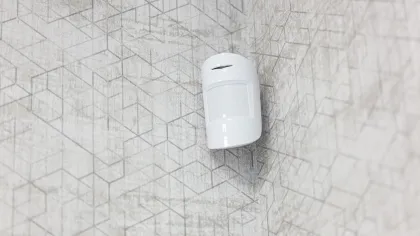 a white light bulb on a white tiled surface