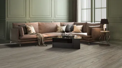 Modern living room with brown sectional sofa, black coffee table, side lamp, and large windows letting in natural light.