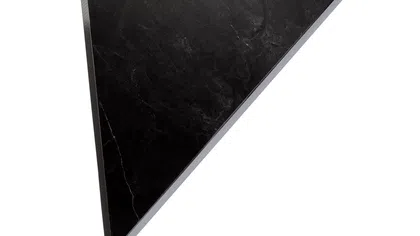 Black triangular marble slab with subtle white veins on a white background.