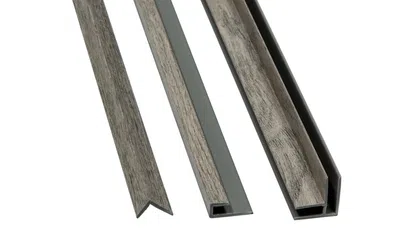 Three gray wood grain textured plastic trim molding strips of varying shapes and sizes on white background.