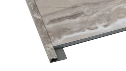 Close-up of a beige marble tile with a matching edge trim piece on a white background