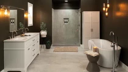 Modern bathroom with white vanity, freestanding tub, glass shower, dark walls, and soft lighting