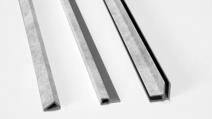 Three sections of metal trim molding in different profiles on white background showing angles and shapes.