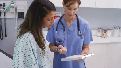 a doctor showing a patient something on the paper