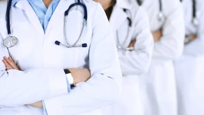 a group of people wearing white lab coats and stethoscopes