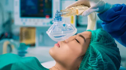 a person in a medical scrubs holding a bottle of liquid