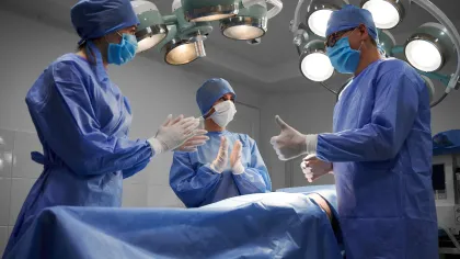 doctors in blue scrubs and masks