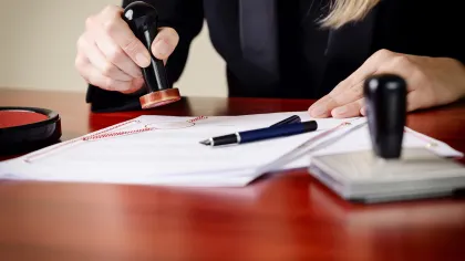 a person writing on a piece of paper