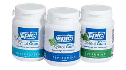 Three containers of Epic Xylitol Gum in Wintergreen, Peppermint, and Spearmint flavors for fresh breath.