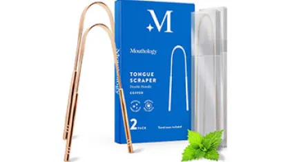 Copper tongue scraper with blue packaging and clear storage case on a white background with green mint leaves
