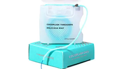 Mint-flavored dental floss container with packaging box in turquoise color on white background
