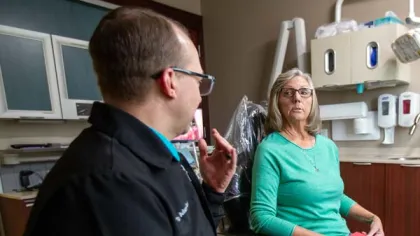 a man and a woman in dental office