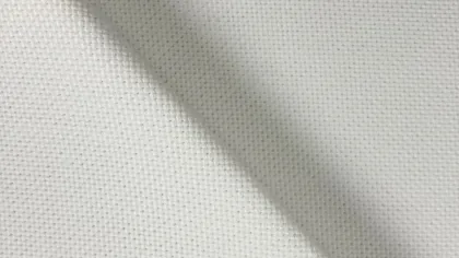 Close-up of white woven fabric with a smooth diagonal fold showing texture and fiber details.