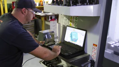 a man working on a CNC machine
