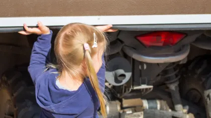 a person with the hands up in front of a car