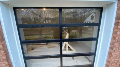 a window with a view of a building and trees