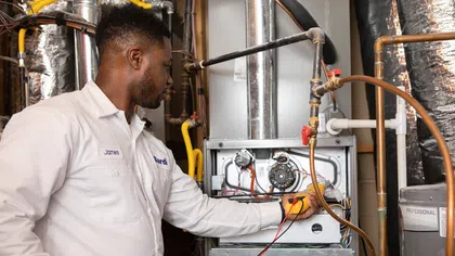 Bardi technician inspecting a residential heating system for replacement