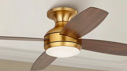 Ceiling fan with a gold finish and wooden blades, featuring integrated lighting for stylish home cooling.