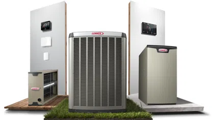 Lennox heating and cooling HVAC units with thermostats displayed on wood and concrete platforms with grass base